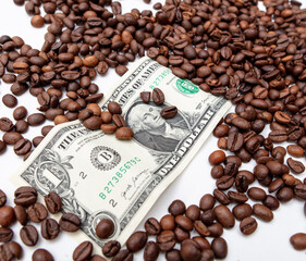 Coffee grains with dollar on a white background.