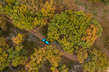 Aerial View Of A Car On Dirt Road In The Forest