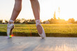 © Cavan Images - Feet of ballet dancer in pointe shoes at sunset with rainbow