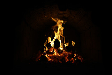 Wall Mural - Background of the flame in the oven. Tongues of fire in a brick fireplace. Fire texture.