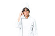 Young caucasian chef  woman over isolated chroma key background having doubts and with confuse face expression