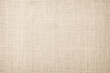 Jute hessian sackcloth burlap canvas woven texture background pattern in light beige cream brown color. Natural weaving fiber linen and cotton cloth texture.