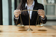 © SOMKID - Young asian lawyer woman working at table office, law and justice concept, law contract.