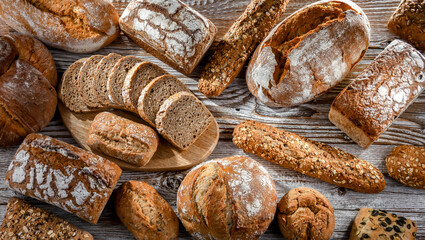 Fototapete - Assorted bakery products including loafs of bread and rolls