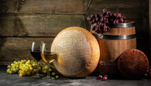 Whole Round Head Of Parmesan Or Parmigiano Hard Cheese And Wine On A Wooden Background. Farmer Market. Place For Text. Long Banner Format
