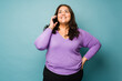 © AntonioDiaz - Cheerful big woman smiling while talking on the phone