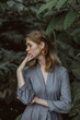 © Kaminski Vadim - A girl poses in a botanical garden among plants