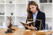 © David - female business woman lawyers working at the law firms. Judge gavel with scales of justice. Legal law, lawyer, documents, advice and justice concept.