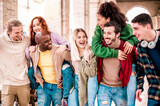 Fototapeta Londyn - Group of multi racial friends having fun together in the town - Young millennials people walking in city ready for school party - Friendship and youth concept about happy and smile at holiday weekend