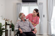© butsaya33 - Caucasian caregiver lady consulting with elderly man patient. Wheelchair disability rehabilitation and nurse at nursing home. Healthcare support and caregiver with senior man for medical help.