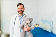 © AntonioDiaz - Portrait of a happy caucasian pediatrician with teddy bear