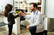 © AntonioDiaz - Cute kid receiving candy from the doctor after a medical check up