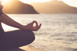 © erika8213 - Woman meditating outdoors at sunset