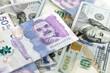 Macro closeup of 50 thousand Colombian pesos bills and 100 dollar bills