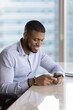 © fizkes - Cheerful satisfied customer man using online service, app on smartphone, sitting at office desk, typing, chatting, getting good news from Internet communication, reading on cell screen