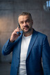 © suvorovalex - Portrait of a handsome young businessman talking on the phone