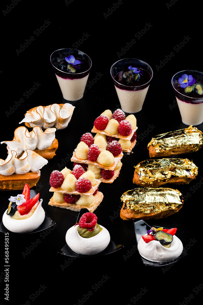 Desserts of the restaurant menu pistachio eclairs, raspberry cakes ...