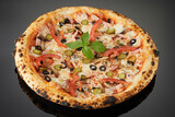 Fototapeta  - Meat pizza with vegetables and olives on a black background