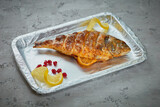 Fototapeta  - Grilled fish dish on gray concrete background