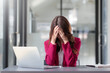 © amnaj - Beautiful Asian businesswoman stressed with work glitches in the office.