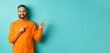 © Mix and Match Studio - Confident happy guy in orange sweater, showing logo banner, pointing fingers right at copy space, turquoise background