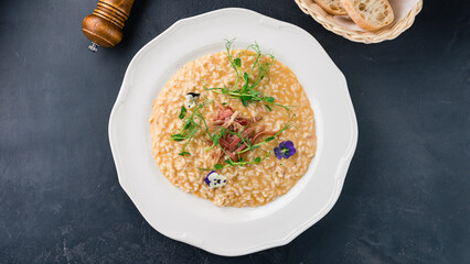 Canvas Print - Italian lunch risotto with parmesan, Parma ham and microgreens.