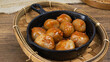 Cilok (Aci Dicolok) is a Sundanese snack originated from Indonesia. served in wok pan with peanut sauce