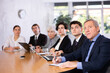 © JackF - Group of diverse business people attending meeting in conference room, discussing work plan