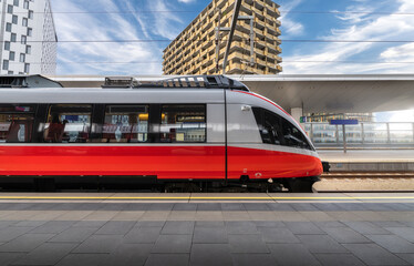Wall Mural - high speed train on the train station at sunset in vienna, austria. beautiful red modern intercity p