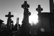 GLASGOW SCOTLAND, January, 2023: Cityscape, Glasgow Necropolis During Sunset With Illuminated Graves And Crosses