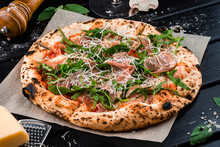 Italian Pizza With Slices Of Beef, Arugula, Parmesan Cheese, Tomato Sauce And Spices On Thick Dough From The Oven.