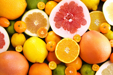 Wall Mural - Colorful bright background of fresh ripe sweet citrus fruits: orange and tangerine, green lime and yellow lemon, grapefruit and kumquat