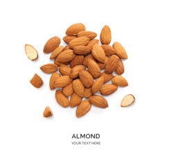 Wall Mural - Creative layout made of almonds on the white background. Flat lay. Food concept. Macro concept. 