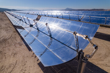 Solar thermal energy (STE) power plant. Mirrors heat water pipes to generate clean energy driving a turbine by water steam. Drone aerial.