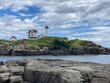 scenic lighthouse in Maine with dramatic sky in the background