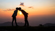 © Tinnakorn - Silhouette of a couple on the mountain, A young romantic couple enjoy a beautiful view of the sun setting over the mountains, love, Valentine's Day.