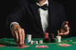 Crop picture of close up man dealer or croupier shuffles poker cards betting holding chips in casino of green table, Dealer man invitation bet playing cards. Casino, poker, poker game concept.