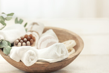 Poster - Spa composition with soap, bath bomb and towels in a wooden bowl.