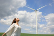 © Antonioguillem - Woman breathing near a wind farm