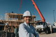 © Westend61 - Happy mature architect wearing hardhat at construction site