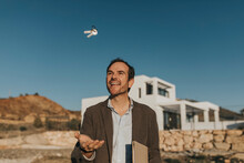 Happy Man Playing With House Key In Front Of Blue Sky