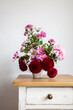 © Westend61 - Bouquet of red and pink autumn flowers on night table