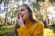© Westend61 - Mature woman eating a slice of tangerine