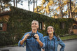 © Westend61 - Curious mature couple with binoculars outdoors