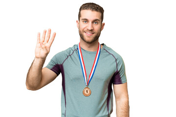 Wall Mural - Young handsome blonde man with medals over isolated chroma key background happy and counting four with fingers