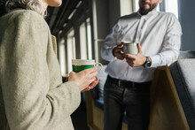 Businessman and businesswoman having a coffee break in office together