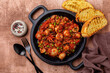 Italian stew cuttlefish  with green peas and tomatoes or seppie con piselli in umido. Toasted bread.