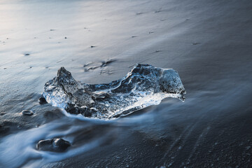 Wall Mural - ice block over black sand in diamond beach