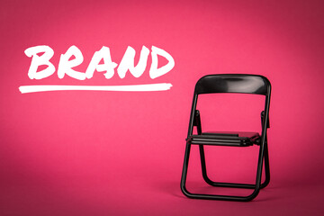 Wall Mural - brand, business concept. black chair on a pink background
