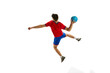 © master1305 - Back view. Throwing ball in a jump. Young man, professional handball player in red uniform playing, training isolated over white studio background. Concept of sport, action, motion, sportive lifestyle